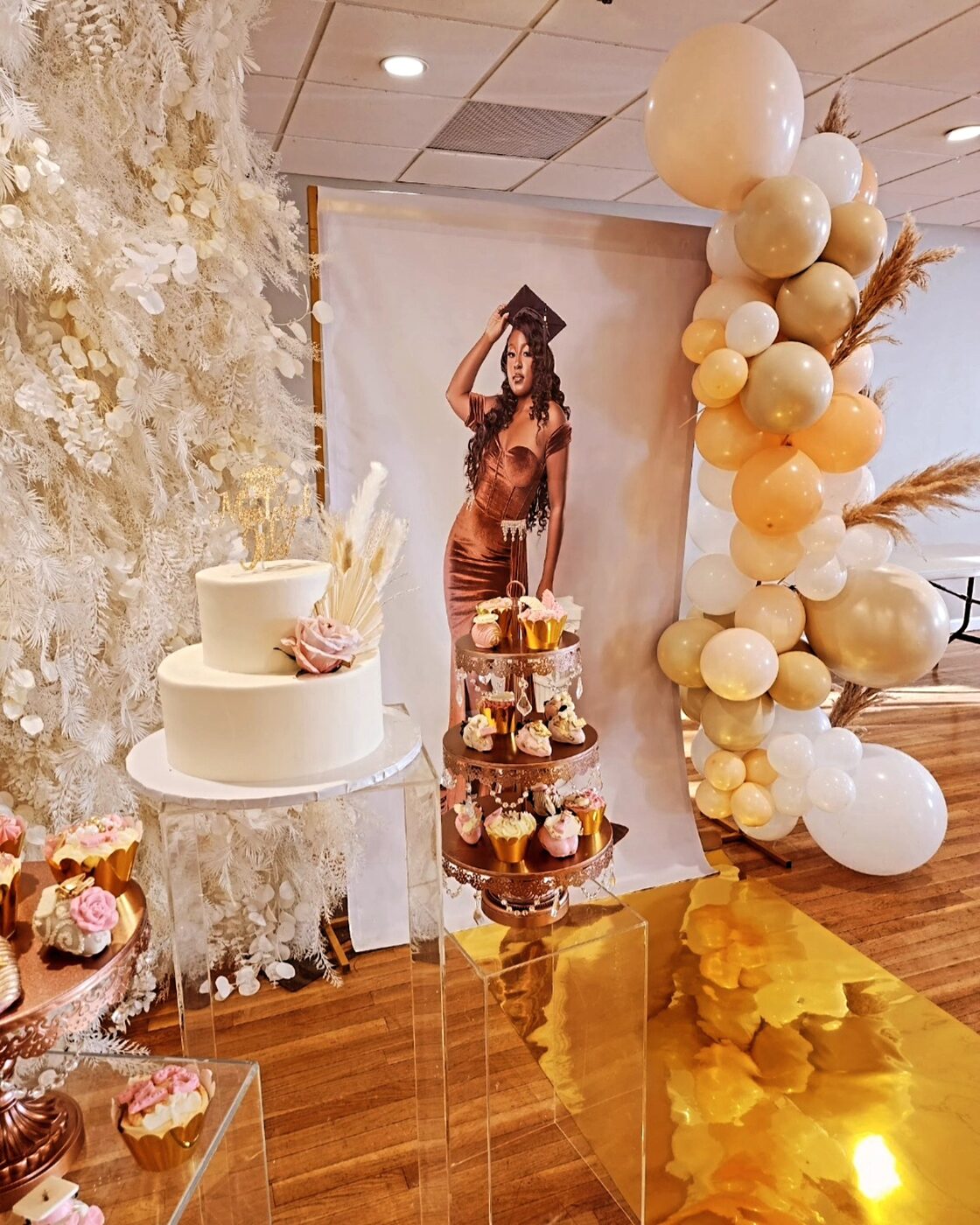 Rose gold and cream dessert display at a graduation celebration